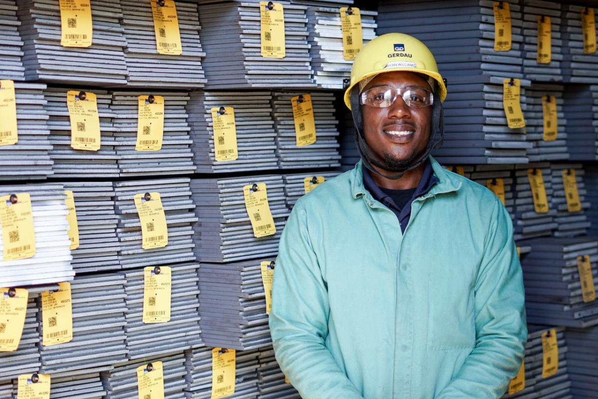 Bryan Williams smiling in front of steel